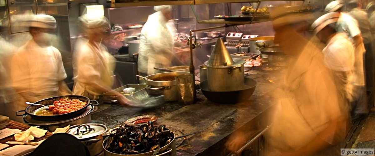 Server presenting dish with composed posture